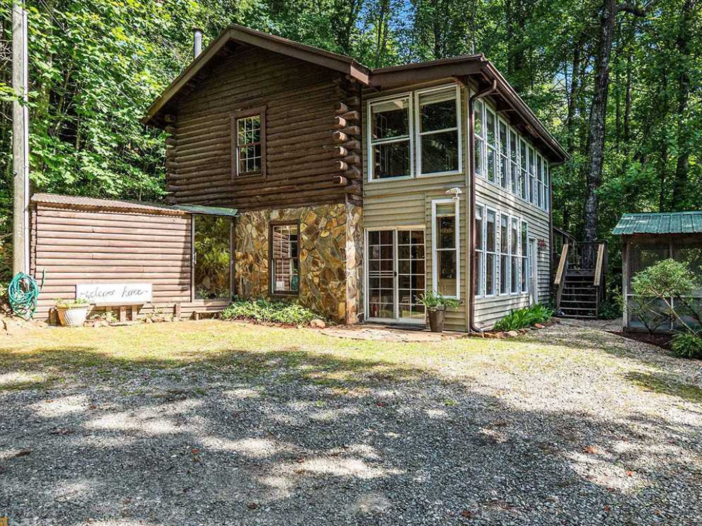 A residential home in the forest, with brown exterior color