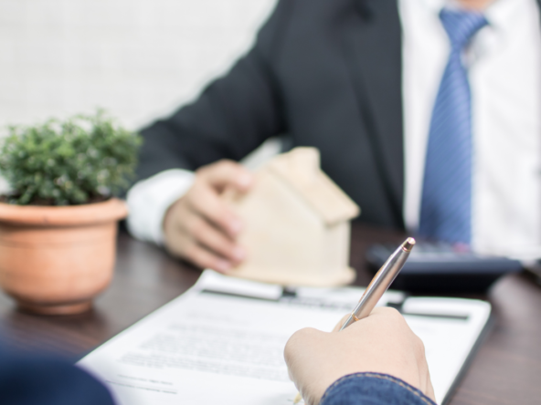 A client signing a paper with a lender