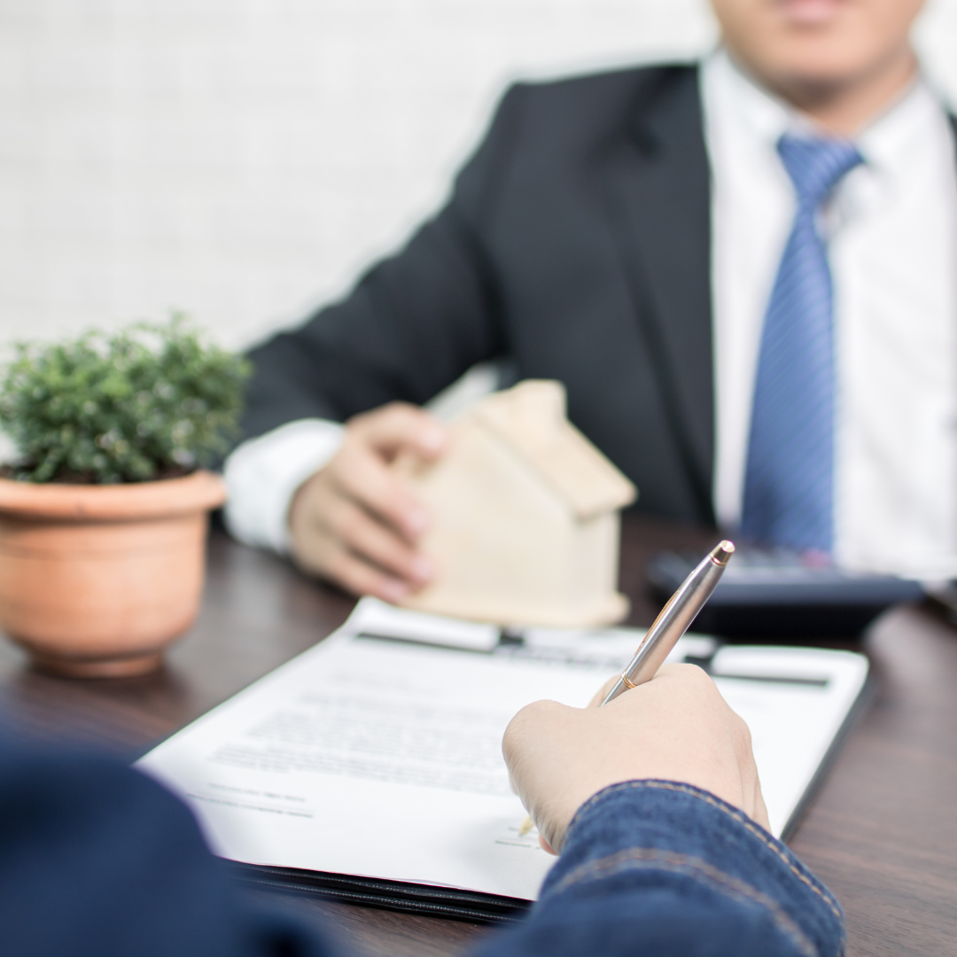 A client signing a paper with a lender